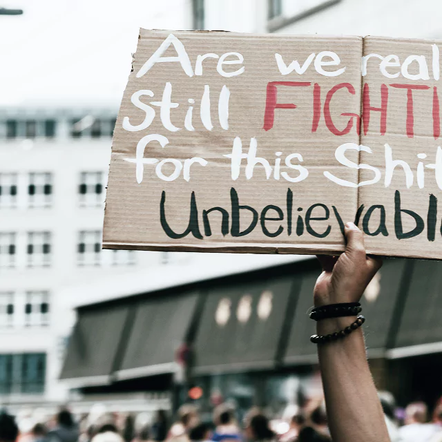 A person questioning the value of a conflict, expressing frustration and disbelief