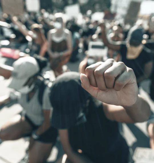 A diverse group of people raising their fists in solidarity