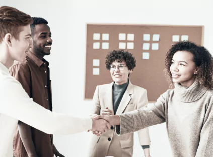 A group of professionals shaking hands in an office setting
