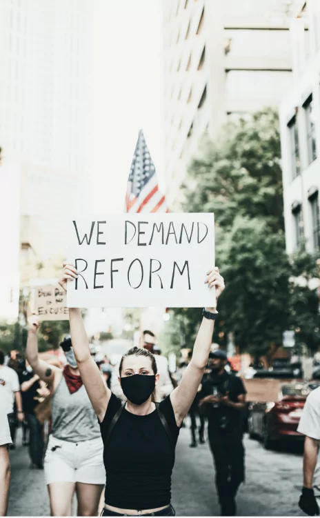 Protest sign displaying the phrase "We demand reform"